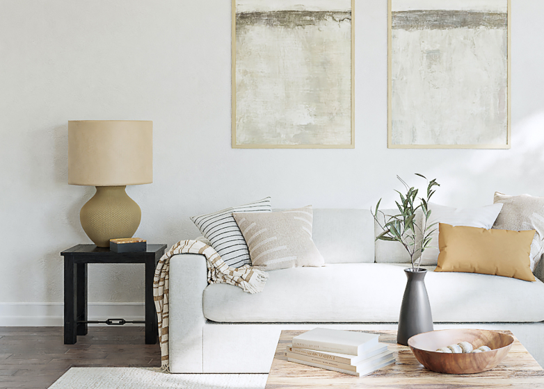 Living room with rug, coffee table, couches, and plants.